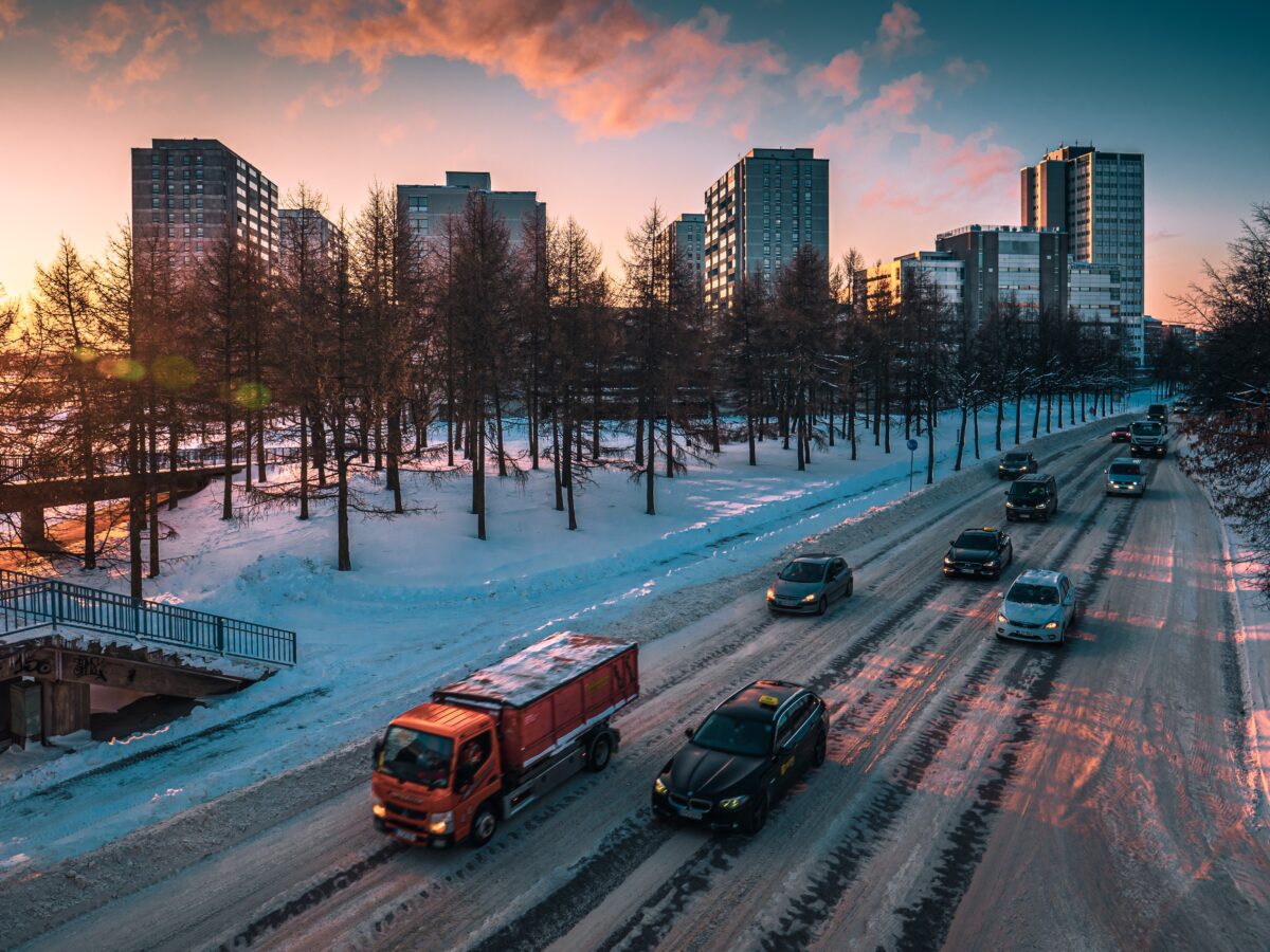 City winter scape, cars on a snowy road