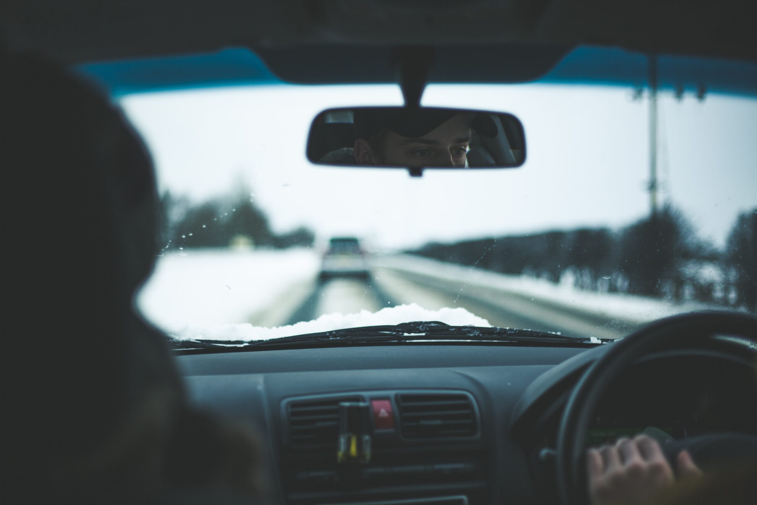 Driving in snow carefully, couple in car in winter